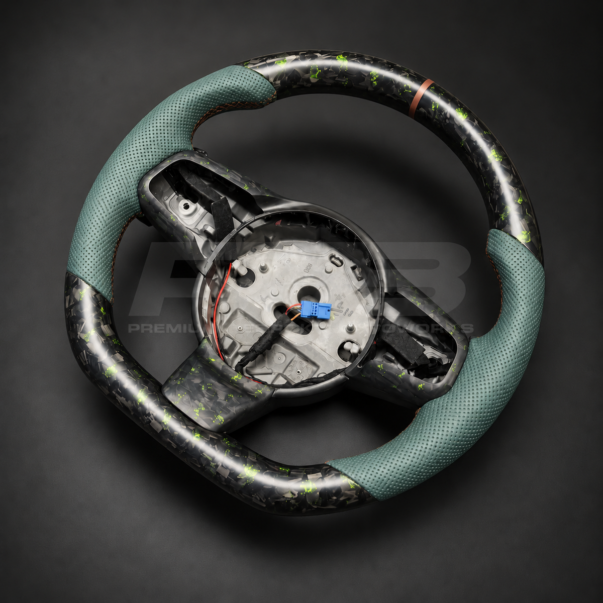 Jaguar F-Type custom steering wheel right angle showing sports shape, green fleck forged carbon top and bottom, green perforated leather grips and bronze marker