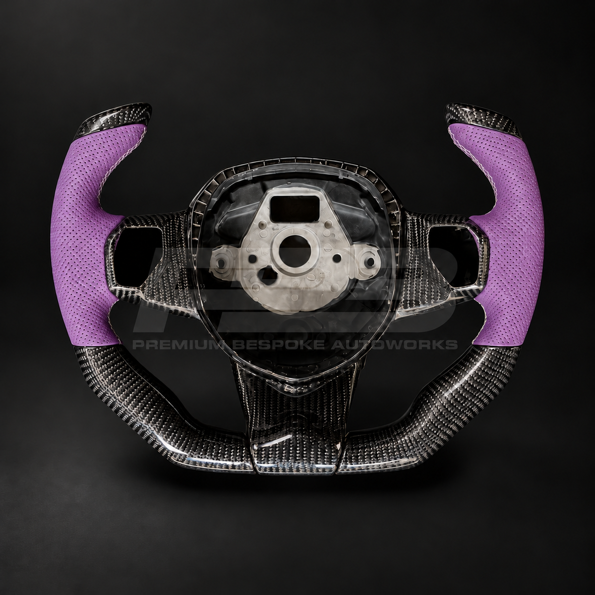 Lamborghini Aventador custom steering wheel, angled front view showing the open top F1 shape and gloss carbon fibre spokes, perforated purple leather grips
