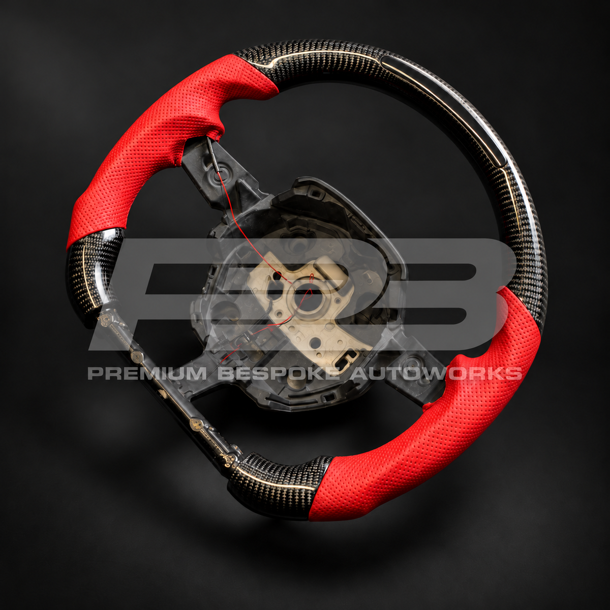 Lamborghini Huracan custom steering wheel angled from the right, showing the RPM light bar in the carbon fibre flat top and the red grips