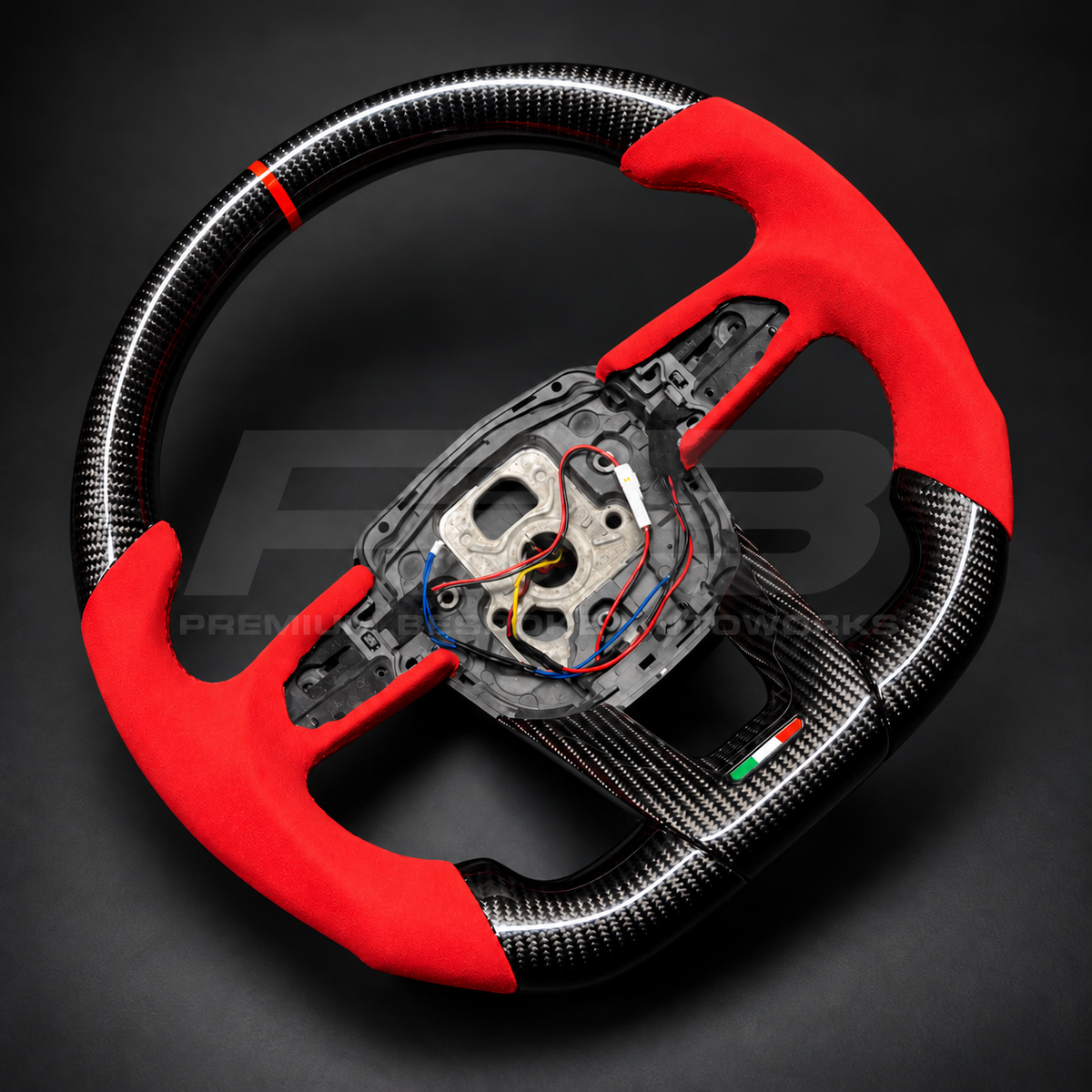 Lamborghini Urus custom steering wheel rotated to show the red Alcantara grips, red stitching and gloss carbon fibre top section