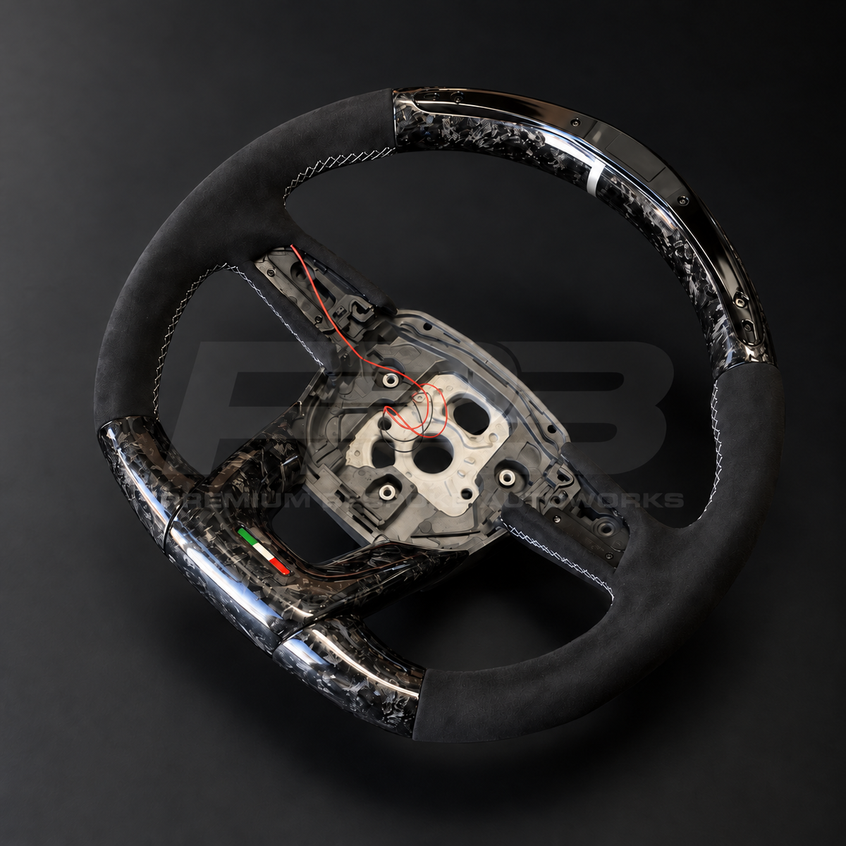 Lamborghini Urus custom steering wheel rotated to show the flat forged carbon bottom section and Italian flag trim detail