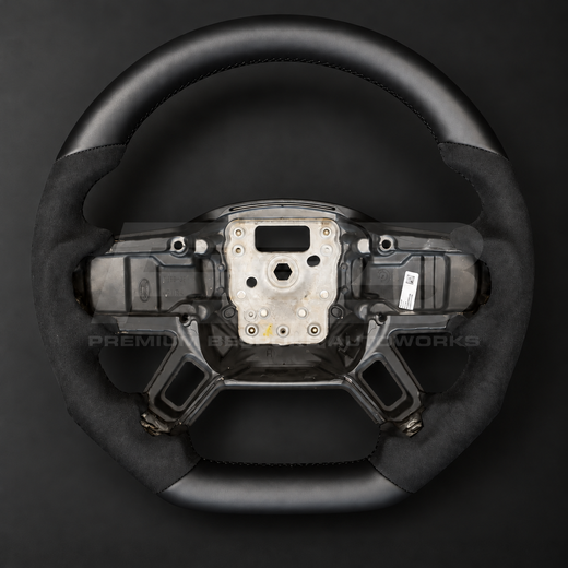 Land Rover Defender L663 custom steering wheel front view, flat bottom, smooth black leather top and bottom with black Alcantara grips