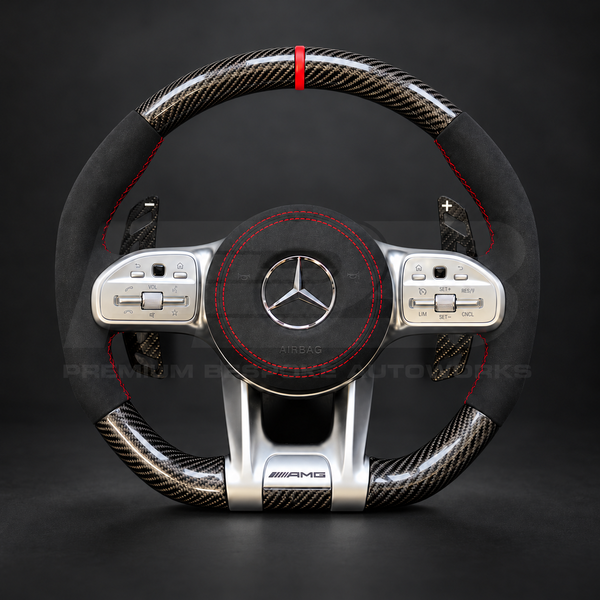 Mercedes-AMG A45 W177 custom steering wheel front view showing gloss carbon fibre, black Alcantara grips and airbag cover, red stitching and red marker