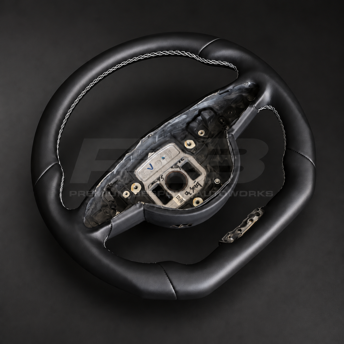 Mercedes-AMG S63 W222 custom steering wheel left angle showing flat bottom, smooth black leather and white stitching
