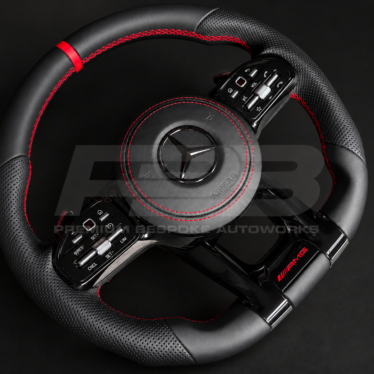 Mercedes-AMG C43 W205 facelift custom steering wheel, angled view showing the red leather 12 o'clock marker, perforated grip and gloss black AMG lower spoke trim