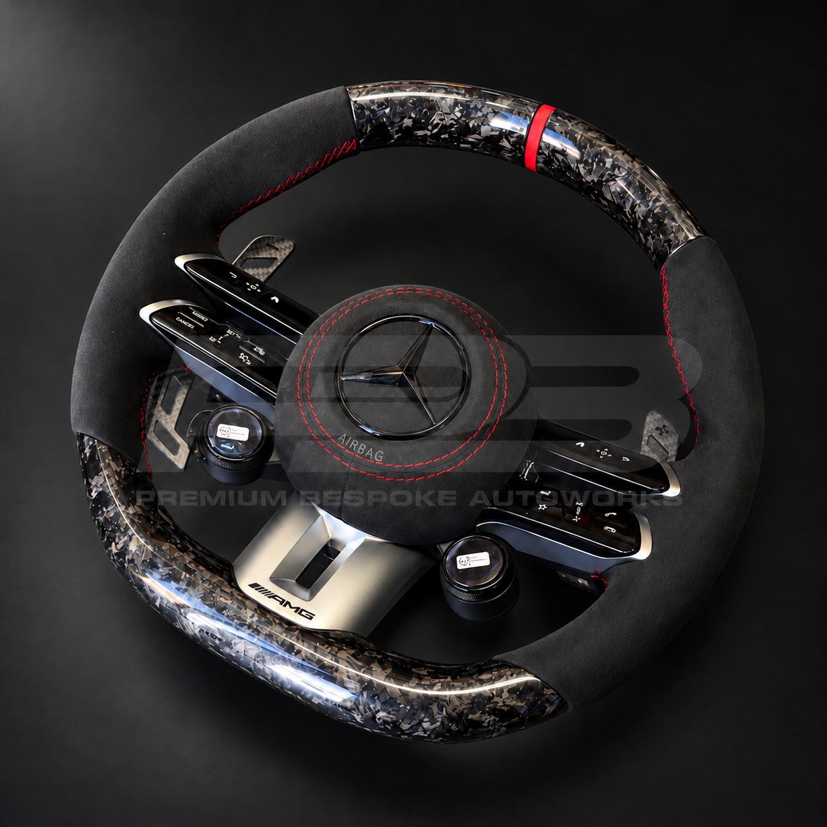 Mercedes-AMG CLA 45 S custom steering wheel rotated to show the forged carbon bottom section, AMG drive mode dials and Alcantara airbag cover