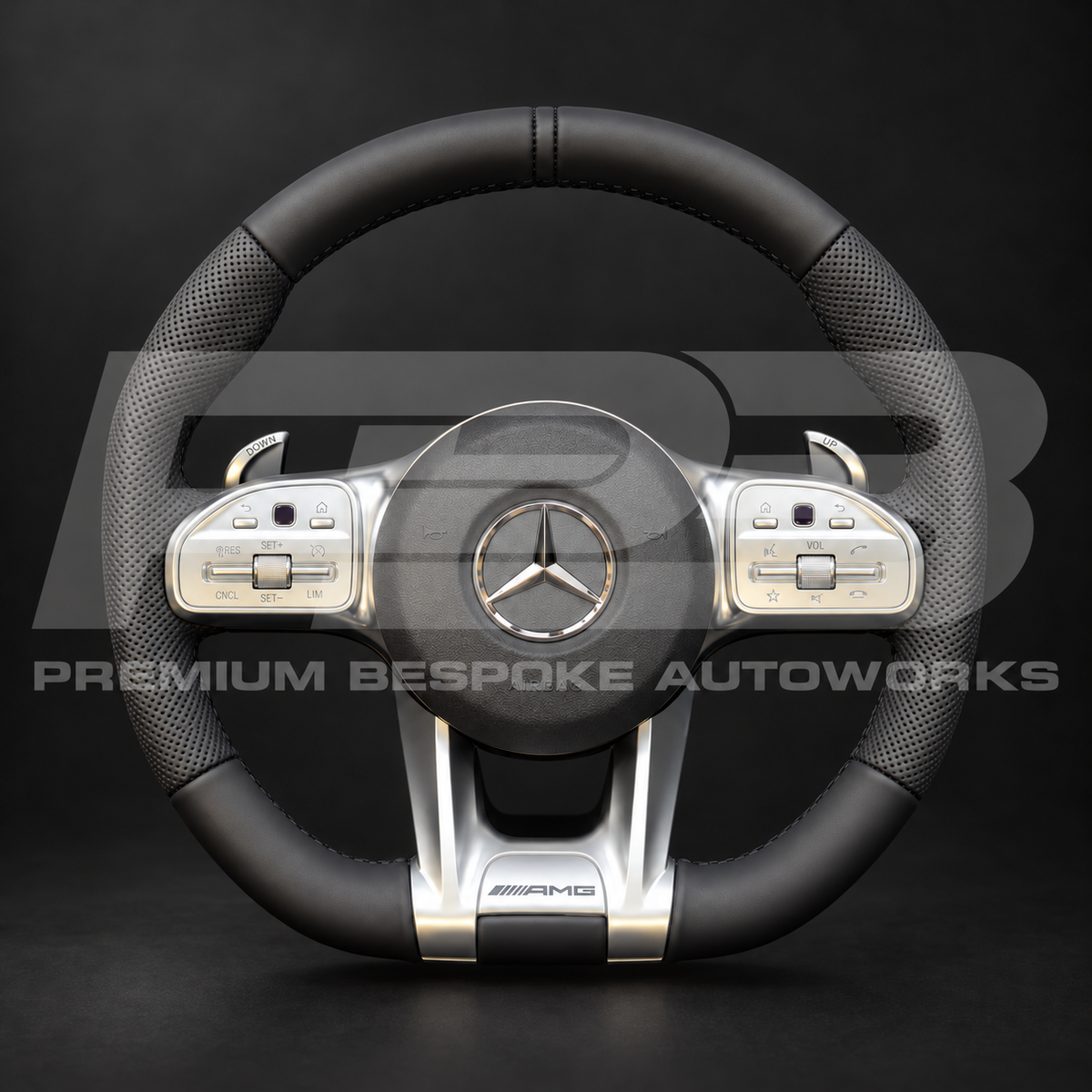 Mercedes-AMG G63 W463 custom steering wheel, front view: smooth black leather top and bottom, perforated black leather grips, black stitching, factory silver trims and paddle shifters, airbag fitted