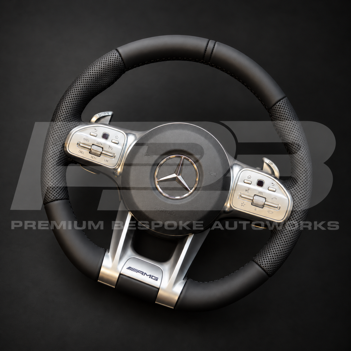 Mercedes-AMG G63 W463 custom steering wheel angled from the right, black leather with perforated grips and silver trims