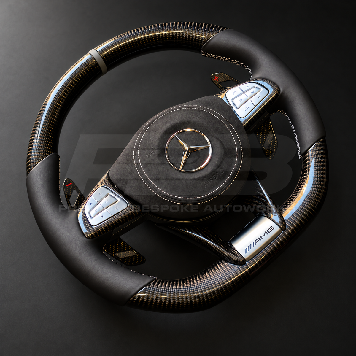 Mercedes-AMG S63 W222 custom steering wheel left angle showing gloss carbon trims, AMG plaque and grey stitching on the Alcantara airbag cover
