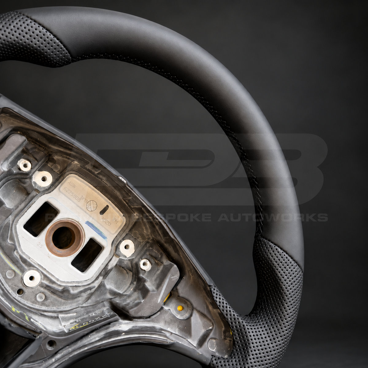 Mercedes X-Class custom steering wheel close up detail showing flat bottom, smooth black leather and black perforated leather grips