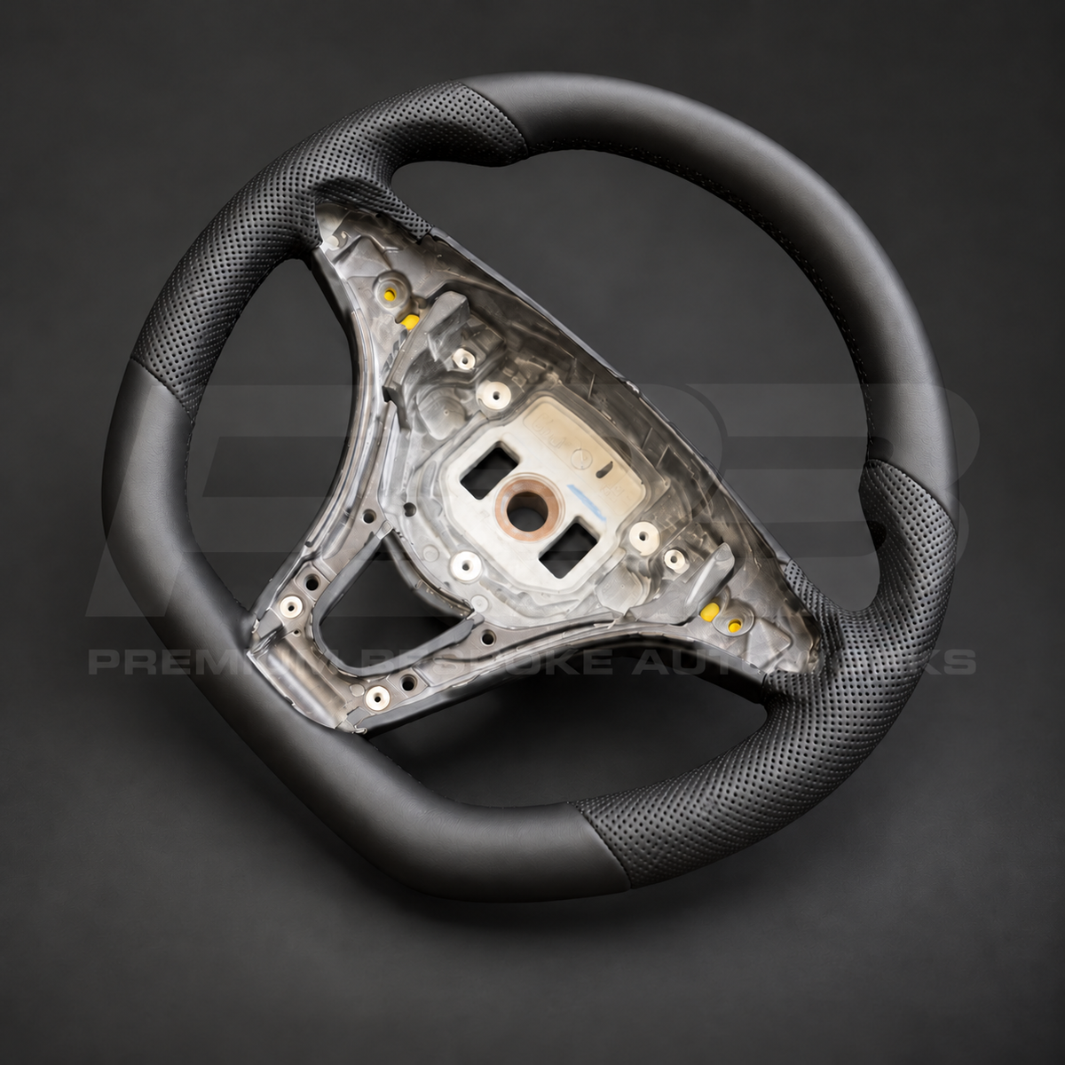 Mercedes X-Class custom steering wheel right angle showing flat bottom, smooth black leather and black perforated leather grips
