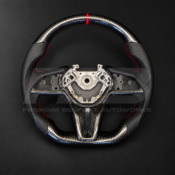 Nissan GT-R R35 EBA custom steering wheel, front view, flat bottom gloss carbon fibre with red 12 o'clock strip, perforated black leather grips, red stitching and carbon fibre trims, customer build by Premium Bespoke AutoWorks