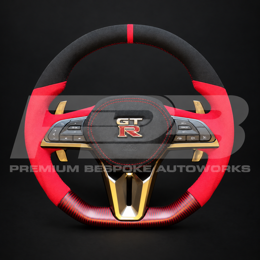 Nissan GT-R R35 EBA custom steering wheel as built, black Alcantara top with red 12 o'clock marker, red Alcantara grips, red carbon fibre bottom section, red stitching, Alcantara airbag cover