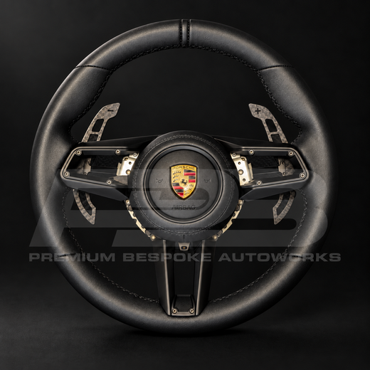 Porsche 911 992 custom steering wheel, front view, GT Sport shape in full black nappa leather with black stitching, nappa airbag cover and magnetic carbon paddle shifters, customer build by Premium Bespoke AutoWorks
