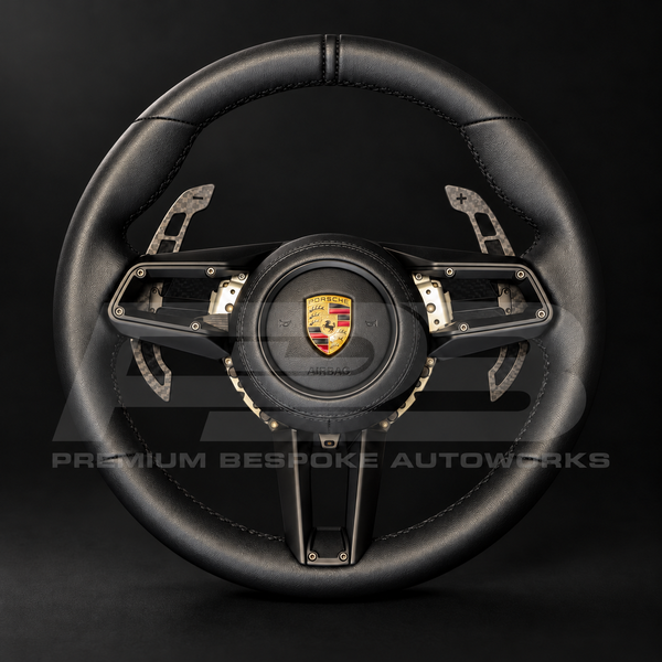 Porsche 911 992 custom steering wheel, front view, GT Sport shape in full black nappa leather with black stitching, nappa airbag cover and magnetic carbon paddle shifters, customer build by Premium Bespoke AutoWorks