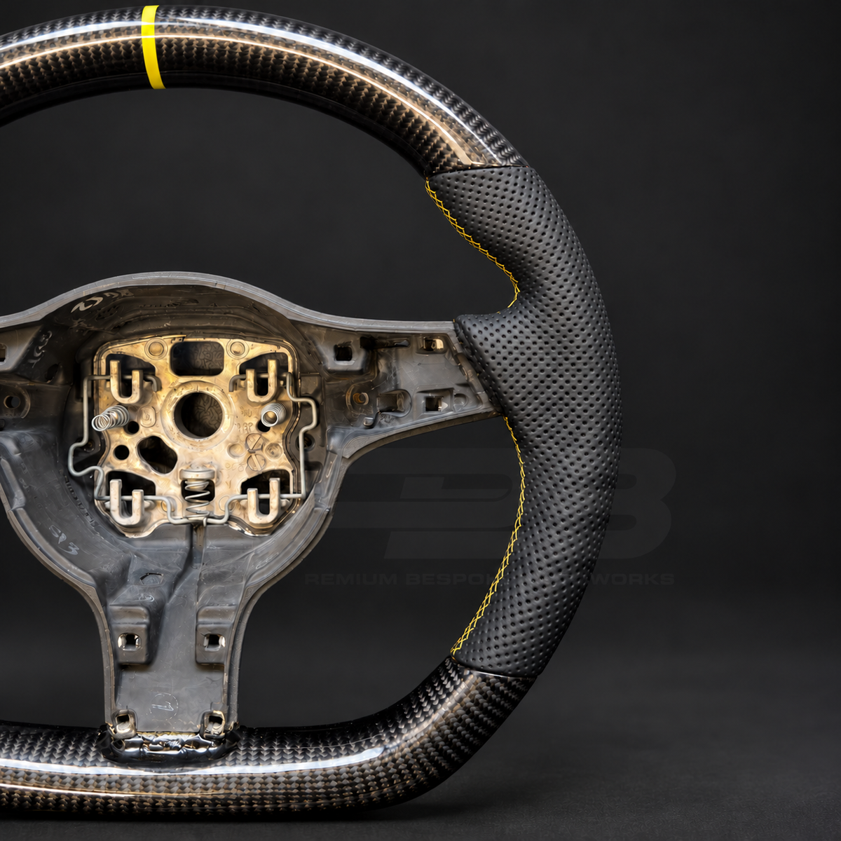 Porsche 911 997.2 custom steering wheel close up detail showing flat top and bottom, gloss carbon fibre, black perforated leather grips, yellow stitching and yellow marker