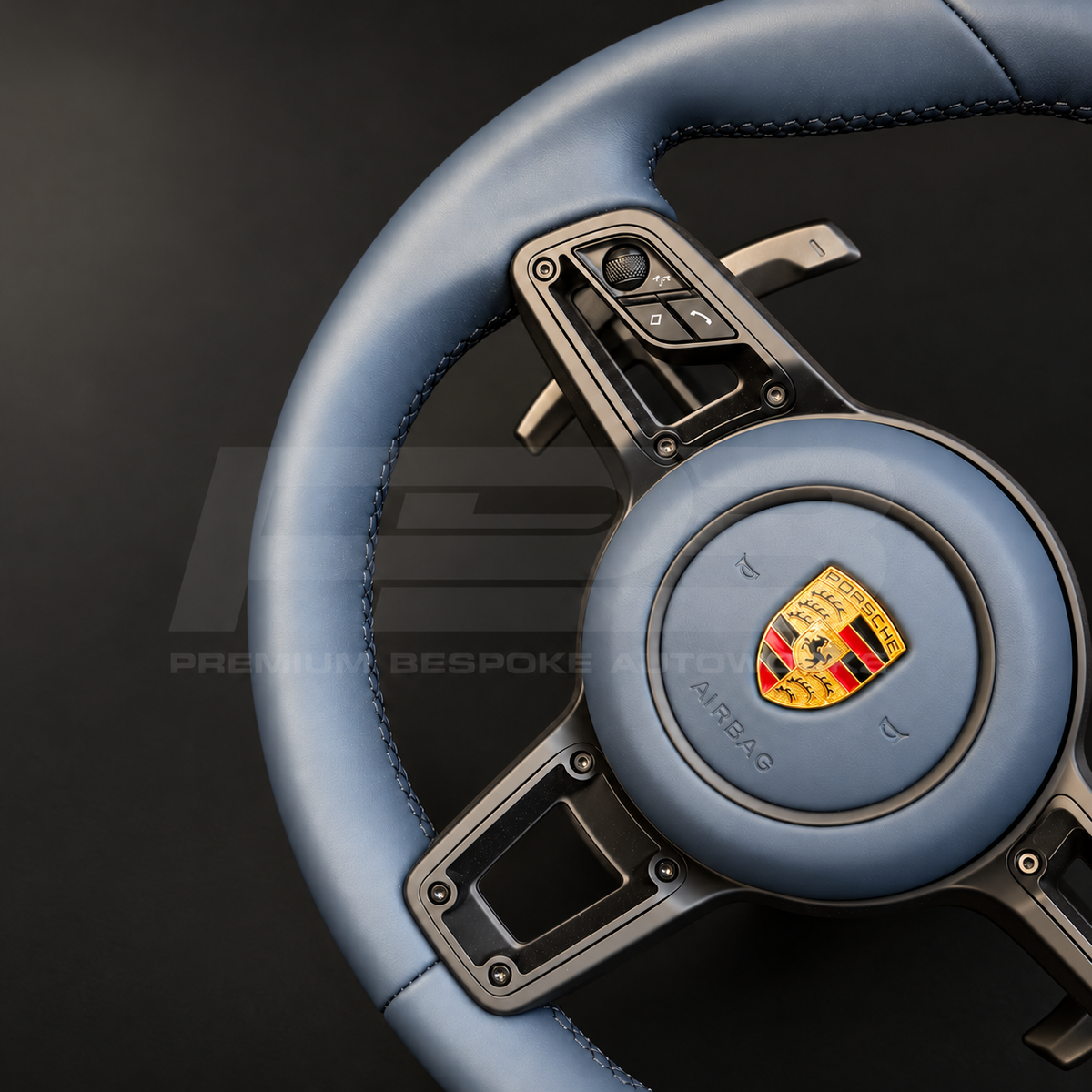 Porsche 911 997 steering wheel upgrade close up detail showing a 991.2 wheel in full blue leather with matching blue leather airbag cover and silver paddles