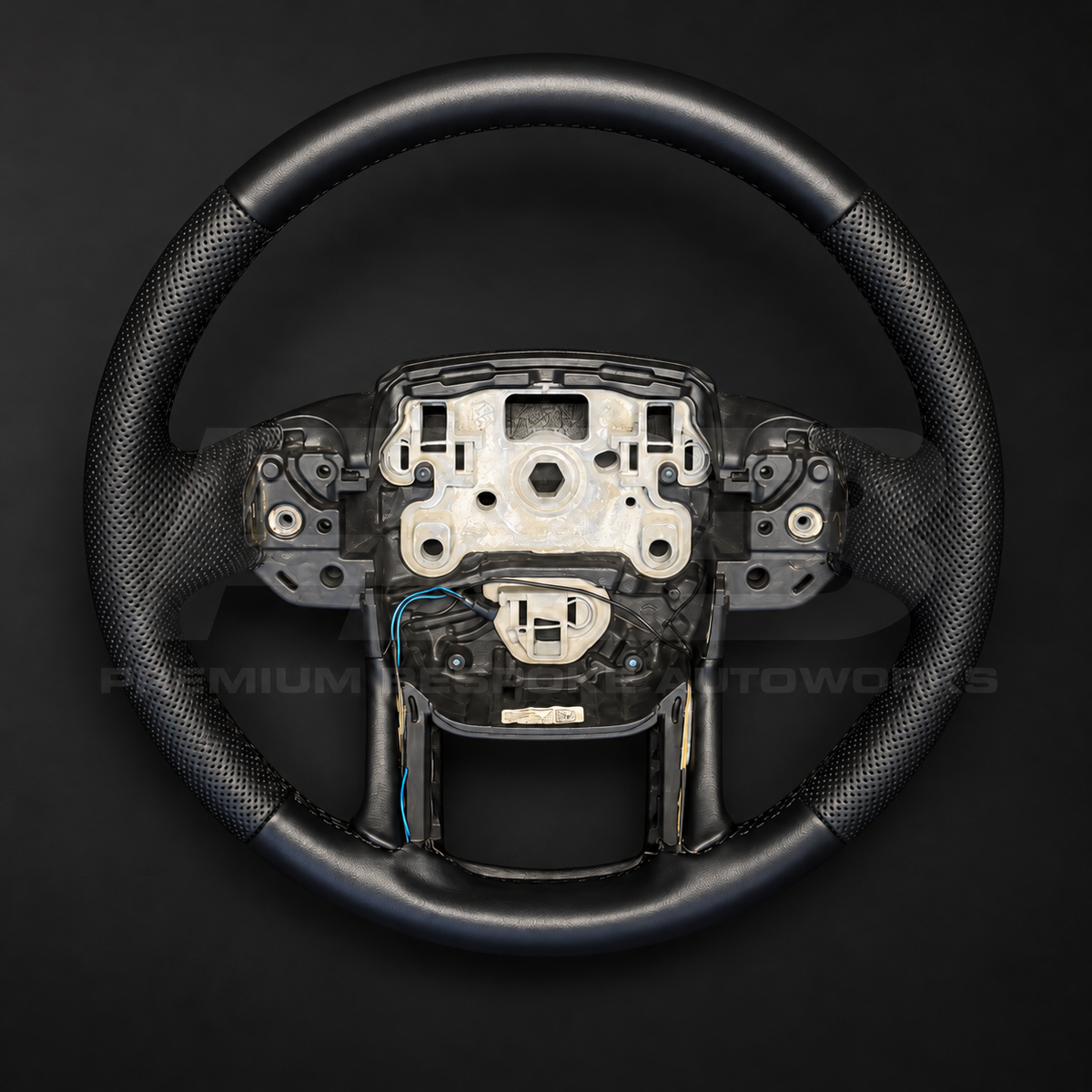 Range Rover Sport L494 custom steering wheel, front view, factory shape in smooth black leather with perforated black grips and black stitching, heated, customer build by Premium Bespoke AutoWorks