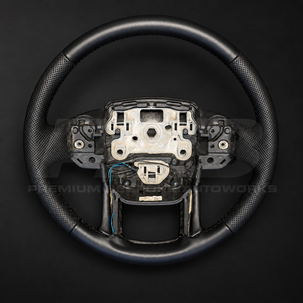 Range Rover Sport L494 custom steering wheel, front view, factory shape in smooth black leather with perforated black grips and black stitching, heated, customer build by Premium Bespoke AutoWorks