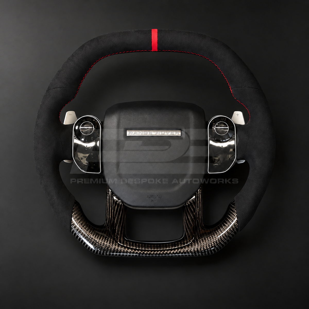 Range Rover Sport L494 custom steering wheel front view, flat top and bottom, black Alcantara top and grips, red 12 o'clock marker, gloss carbon fibre bottom and lower trim